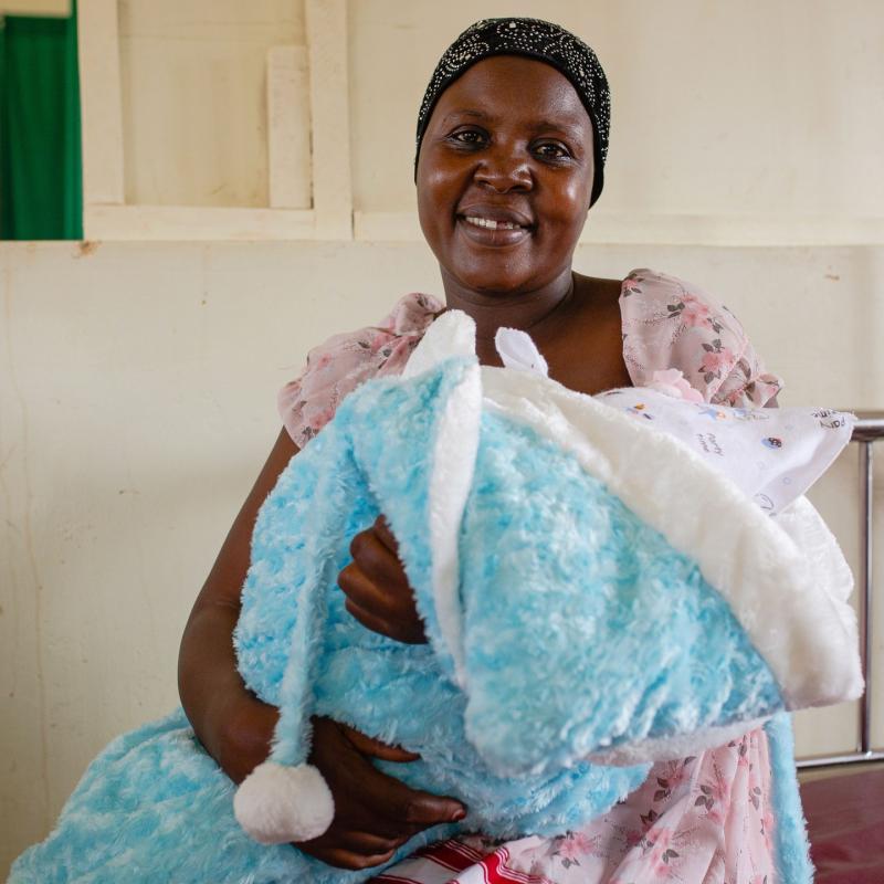 Nabukonde Shamirah cradles her one-day-old baby boy delivered at Nakaloke Health Center III in