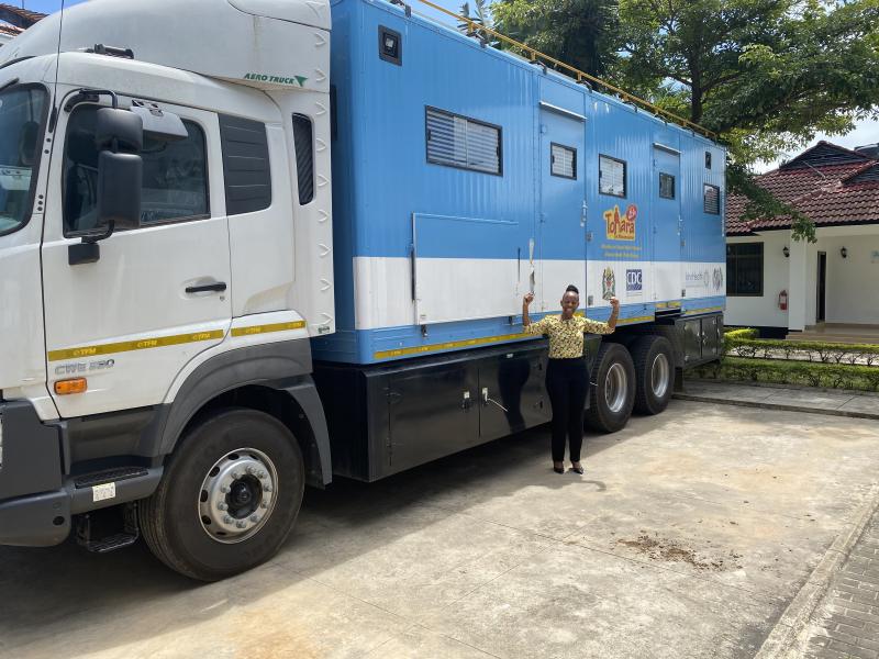Lucy Mphuru in front of a mobile clinic van in Tanzania. January 2021.