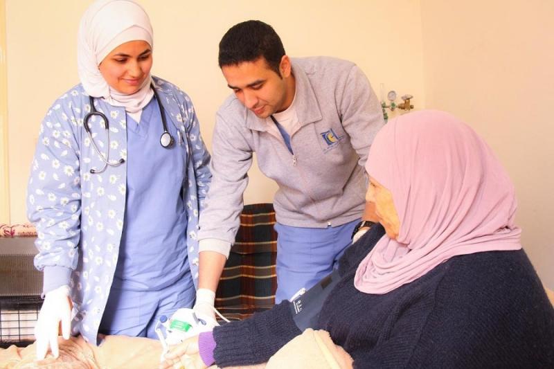 Jordanian home care patient Zuhdiyyah, age 76, receives a visit from her care team--no hospital trip required. Photo: USAID