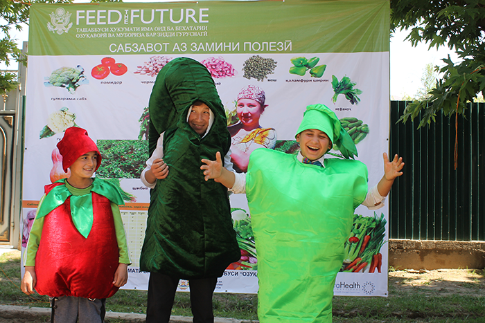 300 villagers in Qubodiyon District, Tajikistan, listened on as children dressed as fruits and vegetables performed for the crowd as part of a nutrition and hygiene campaign to encourage consumption of healthy food and dietary diversity. IntraHealth's Feed the Future Tajikistan Health and Nutrition Activity held six campaigns like this in its very first year. The activity focuses on 12 priority districts in Khatlon Province, which reports some of the highest rates of child stunting, wasting, and underweight levels in the country. Photo by Samariddin Bahriddinov for IntraHealth International.