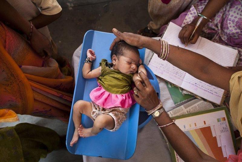 Health workers want their patients to be safe, and they deserve to have the facilities and supplies necessary to make sure that the only thing theyâre giving to patients with their touch is care.
A health worker in India weighs an infant