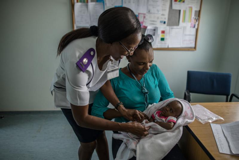 Nurse Ruusa Shipena (left) consults with an HIV-positive mother after the birth of her HIV-negative baby at Shanamutango HIV clinic, Onandjokwe Hopsital, Namibia. Photo by Morgana Wingard for IntraHealth International.