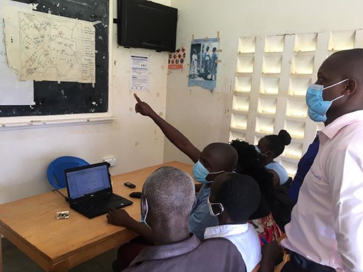 Health facility teams working on GIS maps together. Photo by Irene Mirembe for IntraHealth International.
