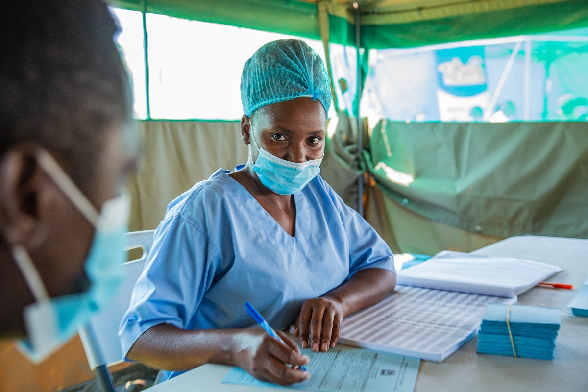 A health worker in Tanzania meets with a client. Photo by IntraHealth International. 