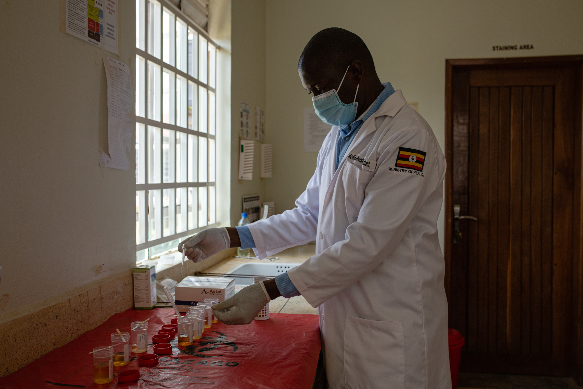 A lab technician at work at Nakaloke Health Center III in Mbale, Uganda. Photo by Esther Ruth Mbabazi for IntraHealth International.