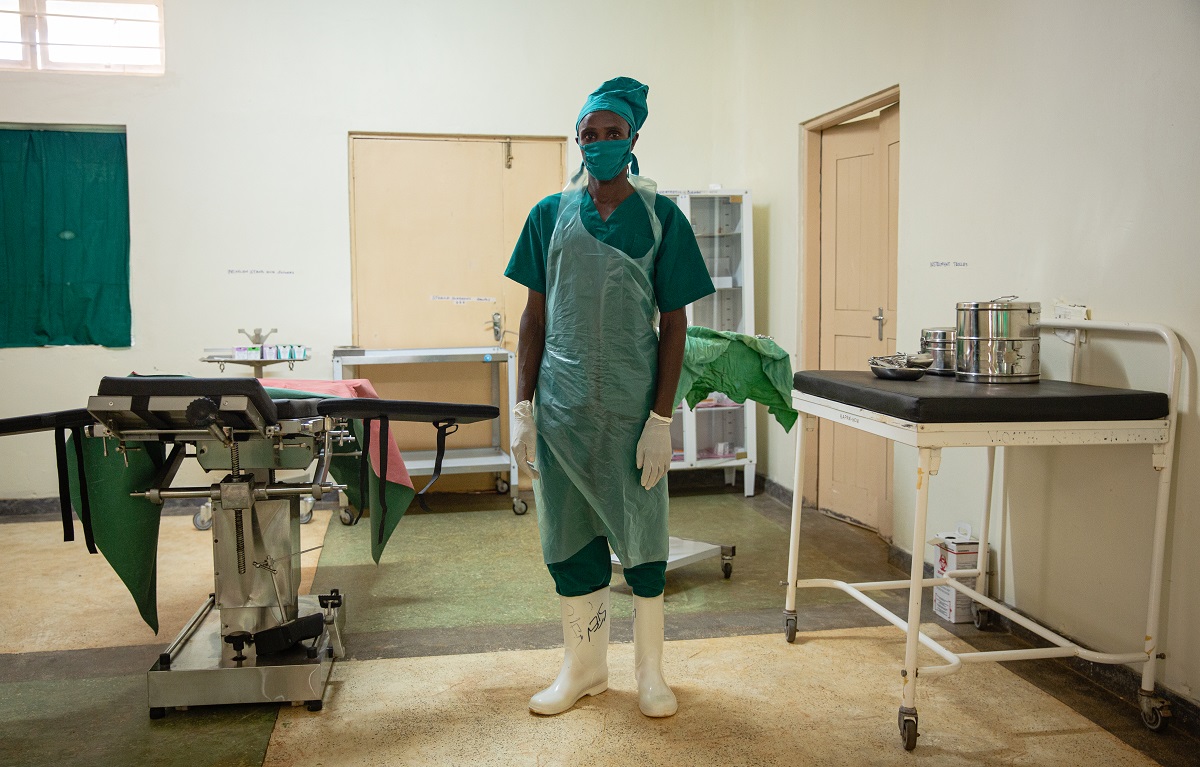 Chemutai, a health worker at the Kaproron Health Center IV in Kween District, Uganda, stands in the operating room for maternal care, which officially opened in May 2020. Photo by Esther Ruth Mbabazi for IntraHealth International.